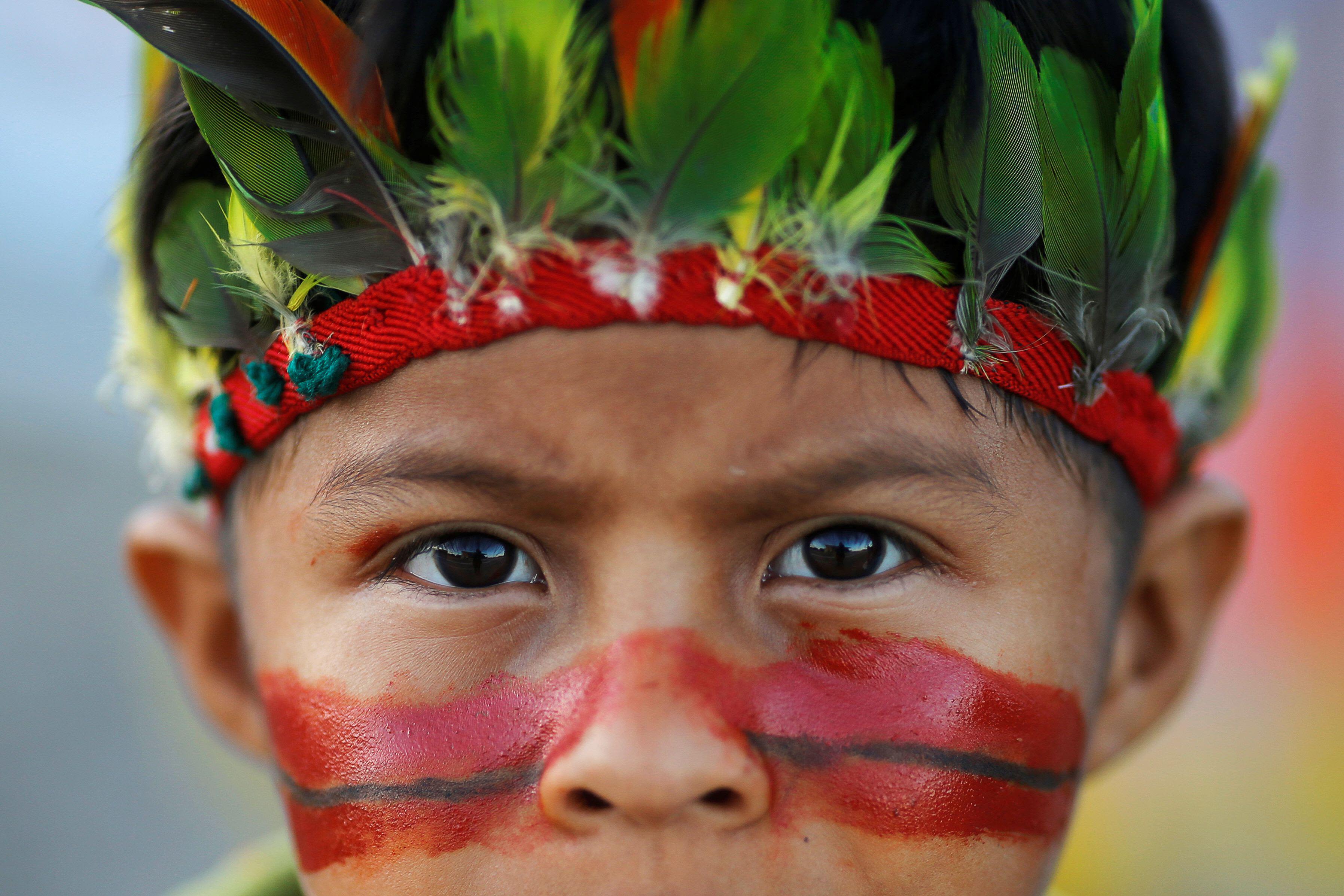 Guarani Kaiowá child seen during a protest to defend indigenous land, outside Brazil's Supreme Federal Court in Brasilia, Brazil, June 2019 © REUTERS / Adriano Machado / Alamy Stock Photo